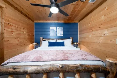 Bedroom Bliss: Rustic elegance with a stunning wood frame bed and chic blue accents!