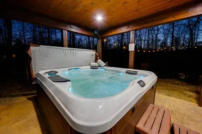 Outdoor Oasis: Unwind in the bubbling hot tub under the stars surrounded by nature's beauty!