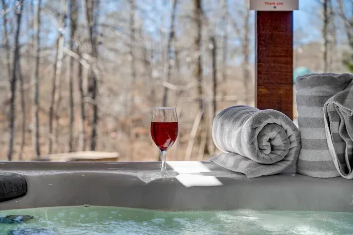Hot Tub Oasis: Unwind with a drink while surrounded by nature's tranquil beauty!
