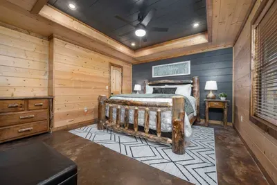 Master Bedroom: Drift off in a stunning log bed surrounded by rustic charm and modern comforts!