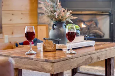 Living Room: Sip wine by the fireplace while surrounded by rustic charm and warm ambiance!