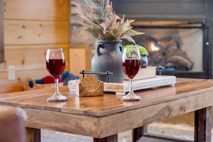 Living Room: Sip wine by the fireplace while surrounded by rustic charm and warm ambiance!