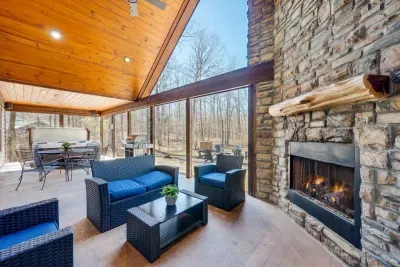 Outdoor Living Room: Enjoy serene woodland views from this stylish space with a cozy fireplace!