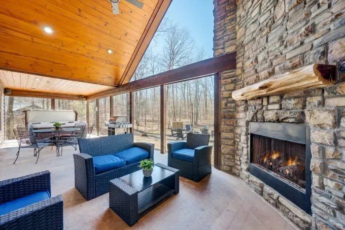 Outdoor Living Room: Enjoy serene woodland views from this stylish space with a cozy fireplace!