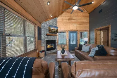 Living Room: Warm wood accents and a crackling fire create the perfect retreat for relaxation!