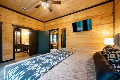 Master Bedroom: Experience modern comfort with wood accents, sleek furnishings, and nature views!