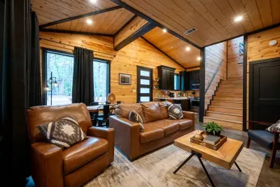 Living Room: Revel in stylish comfort with high ceilings, sleek decor, and nature views!