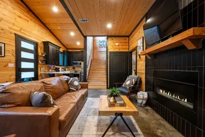 Living Room: Sleek design with a warm ambiance, perfect for relaxing evenings by the fire!