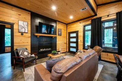 Living Room: Relax by the fireplace and enjoy nature views through expansive windows!