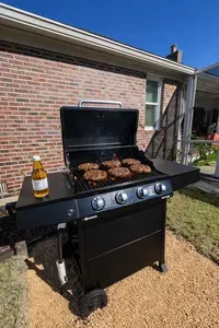 4-burner gas grill on patio—perfect for sunny backyard BBQ nights.