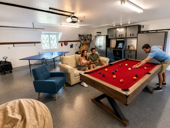 Spacious game room with pool, ping pong, arcade & comfy lounge seating