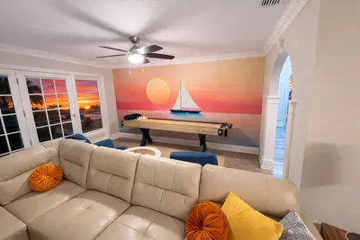 Coastal lounge with sunset views, shuffleboard, and chic sectional