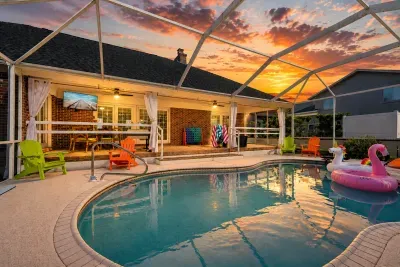 Screened private pool with sunset views and cozy covered patio seating