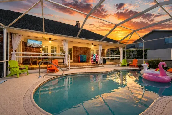 Screened private pool with sunset views and cozy covered patio seating