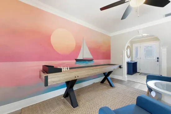 Set up a shuffleboard tournament in the corner nook, sailboat-mural backdrop setting the scene