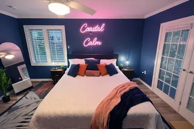 Coastal-chic retreat: neon mood lighting, French doors, plush queen bed