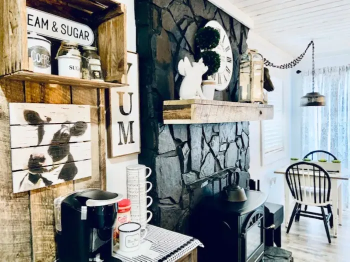 Cozy farmhouse nook with coffee bar, stone hearth, and sunny dining.