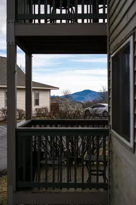 Private porch with seating and mountain views, parking steps away