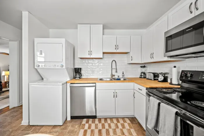 Bright, fully equipped kitchen with in‑unit laundry and sleek finishes