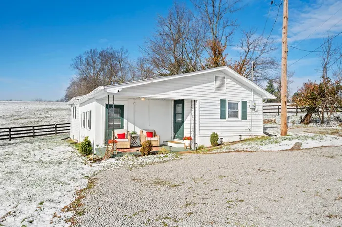Cozy country cottage with porch seating and serene field views