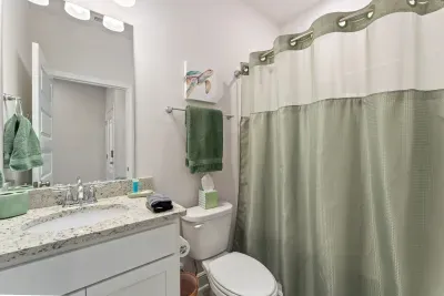 Shared bathroom with bunk room and calming coastal king bedroom.  