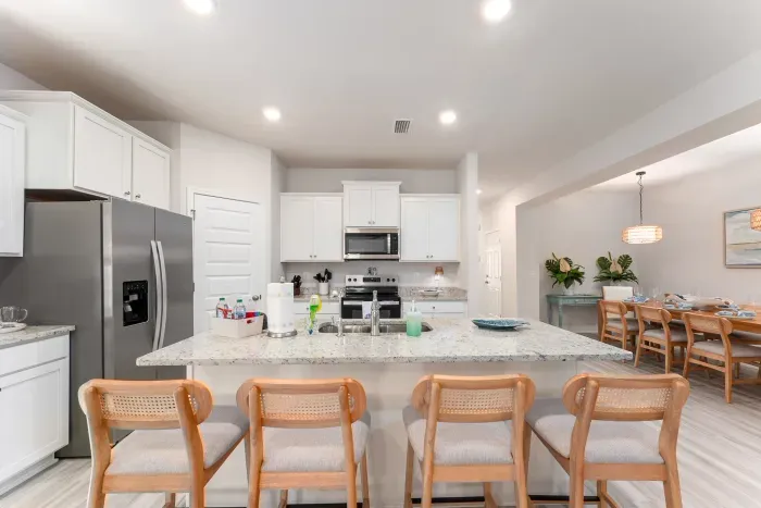 Kitchen area with 4 bar stools for more dining.