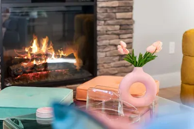 Living Room: Gather around the fire with stylish seating and vibrant decor for fun-filled evenings!