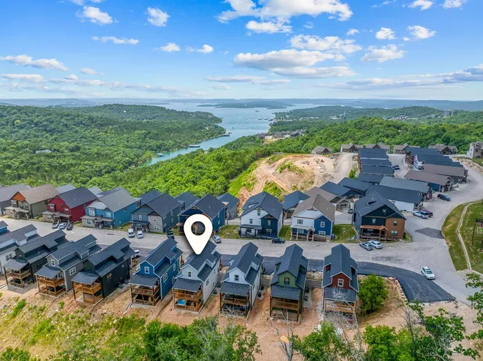 Take in the beauty of the community from above, surrounded by charming homes and peaceful Ozark scenery. ✨