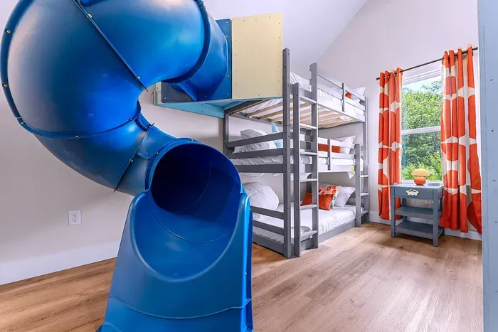 Let the fun begin! This bunk room features 6 beds, a slide, and a climbing wall for nonstop excitement.