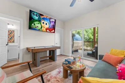 A colorful game room where you can play, relax, and enjoy movie nights together. 🎮🍿