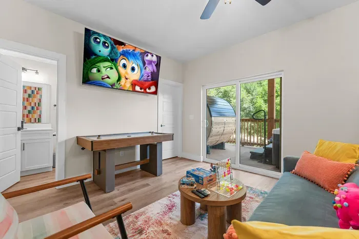 A colorful game room where you can play, relax, and enjoy movie nights together. 🎮🍿