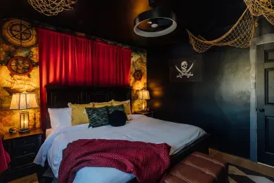 An adventure-filled Pirates of the Caribbean–inspired bedroom designed with a bold black accent wall and detailed pirate-themed accents.