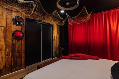 Pirates of the Caribbean–themed bedroom with a bold black accent wall and adventurous décor.