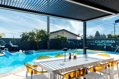 Outdoor dining and lounge area beside the pool, perfect for relaxing, enjoying meals, and spending quality time in a peaceful setting.