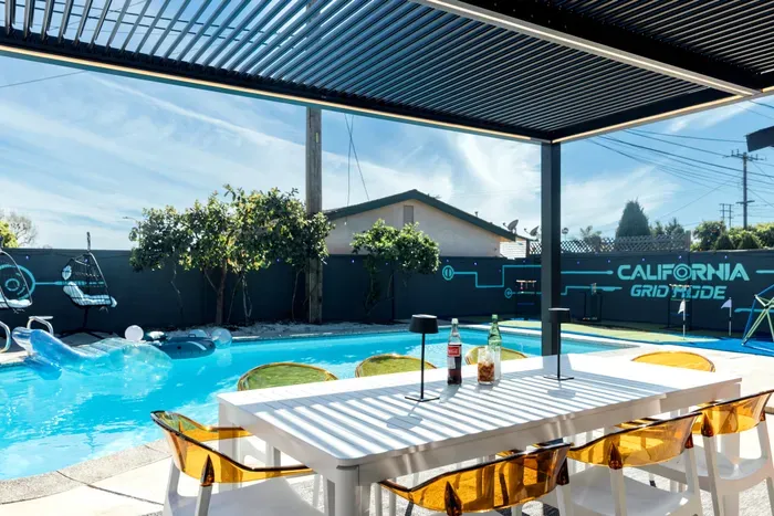 Outdoor dining and lounge area beside the pool, perfect for relaxing, enjoying meals, and spending quality time in a peaceful setting.