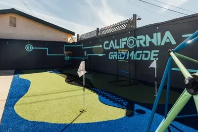 Fun outdoor game area featuring turf flooring and interactive setups, perfect for entertainment, friendly competitions, and enjoying time outside with guests.