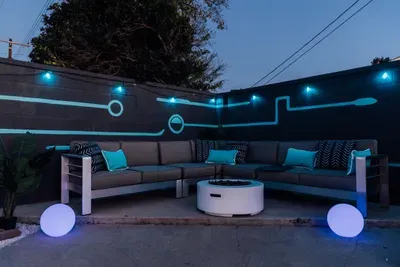 A relaxing backyard featuring a comfy outdoor sofa, perfect for lounging, socializing, and enjoying the fresh air in a cozy setting.