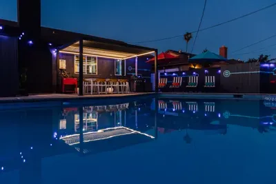 A cozy, beautifully lit pool area at night, creating a warm and relaxing ambiance—perfect for evening swims and unwinding under the lights.
