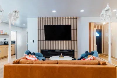 Charming living room with artistic décor, cozy seating, and a warm, inviting atmosphere perfect for relaxing.