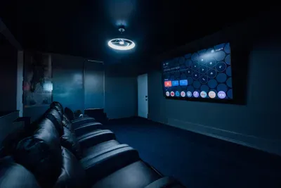 Private home movie theater with comfortable seating, perfect for watching films in a cozy, cinema-style setting.