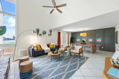 Cozy up at Seabreeze Villa! This inviting living room features a warm fireplace and coastal-inspired decor—perfect for relaxing after a day at the beach. Your seaside escape is just a booking away! ✨