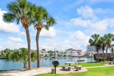 Start your day with calming lake views just beyond the backyard at Seabreeze Villa.