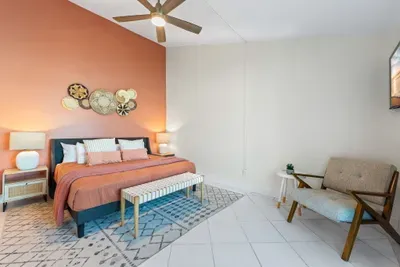 This spacious ensuite bedroom features warm coastal tones, cozy textures, and a private bathroom—perfect for guests who prefer no stairs and easy access to everything.