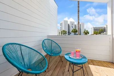 Catch coastal breezes and a peek of the beach from the kids' bunkroom balcony — the perfect spot for a glass of pink lemonade and a little sunshine between adventures.