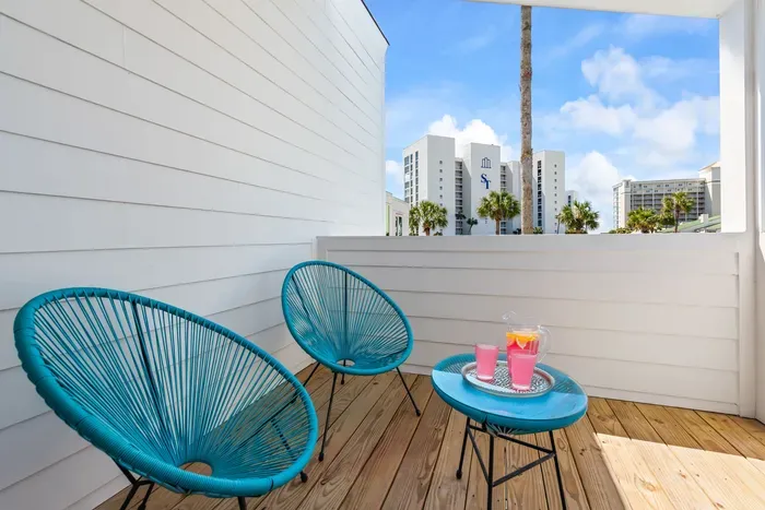 Catch coastal breezes and a peek of the beach from the kids' bunkroom balcony — the perfect spot for a glass of pink lemonade and a little sunshine between adventures.
