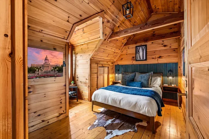 Cozy second-floor queen bedroom featuring a Roku TV.