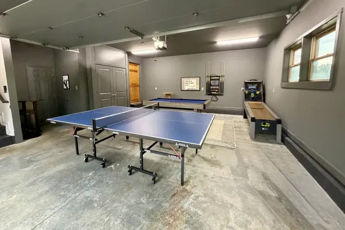 The garage game room features billiards, table tennis, darts, and roll ball.