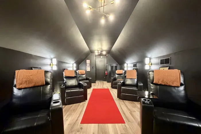 Private theater with reclining seats and trays for movie nights.