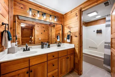 Shared upstairs bathroom with a tub and shower combination.