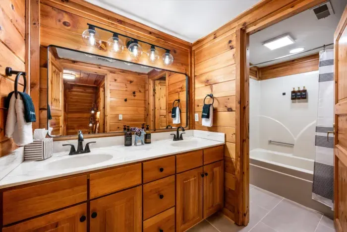 Shared upstairs bathroom with a tub and shower combination.